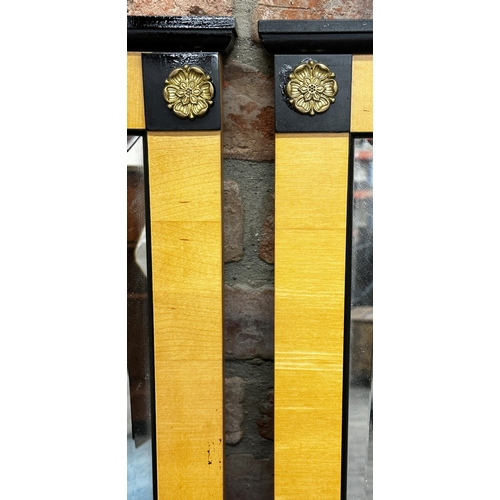 1131 - Pair of Bedemeier style wall mirrors with ebonised highlights and gilt metal flowerhead roundels, ea... 