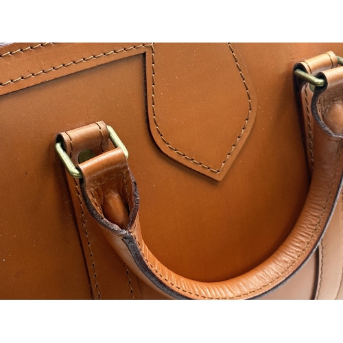 353 - Swaine Adeney Brigg medium sized tan leather tote bag with gold-tone hardware. Features interior zip... 