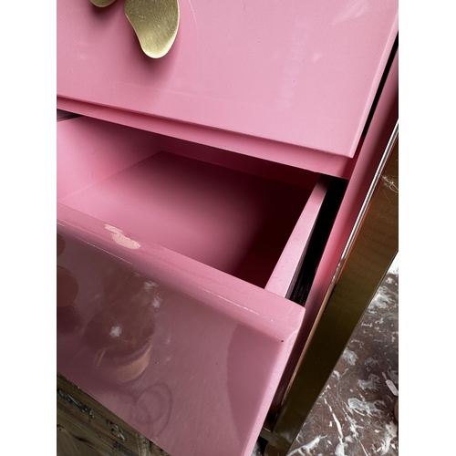 28 - Novelty pink laminate bank of drawers with gilt metal supports and butterfly handles, 78cm high x 40... 