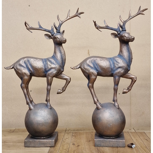 100 - Pair of bronzed resin stags on atlas stone plinths, 67cm high (2)