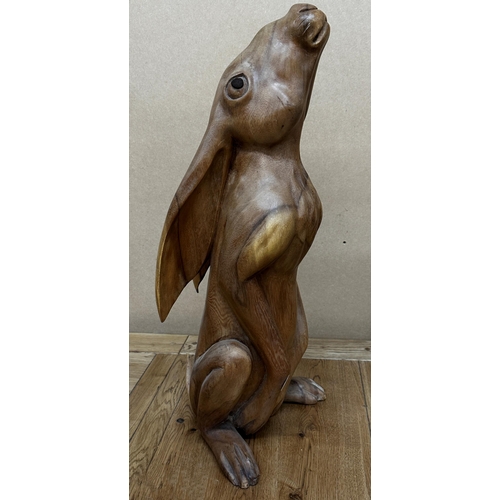 112 - Carved wooden study of a seated hare, 60cm high