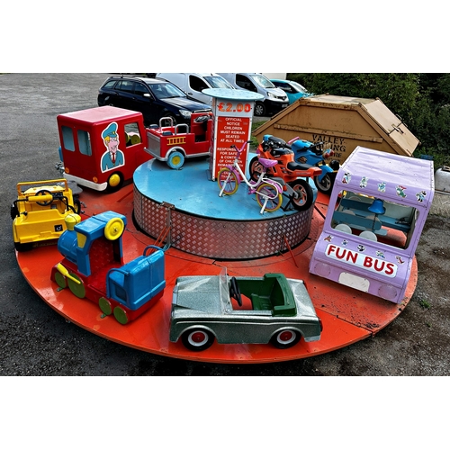 1 - A merry-go-round-style carousel toy vehicle ride funfair attraction featuring cars, a train, motorbi... 