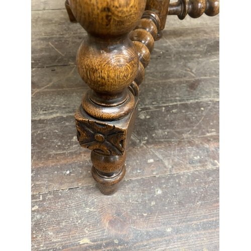 52 - 19th century oak gypsy type table, the octagonal top carved with scrolled acanthus upon three bobbin... 