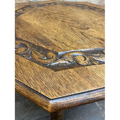 52 - 19th century oak gypsy type table, the octagonal top carved with scrolled acanthus upon three bobbin... 