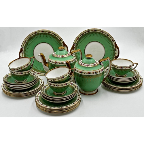 438 - Royal Doulton tea service, Rd No 773350, with floral and gilt bands on a green ground, comprising tw... 