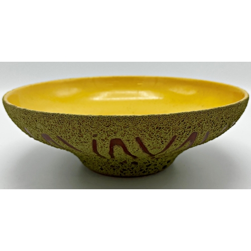 465 - West German studio pottery bowl with yellow glazed interior and green textured exterior with repeati... 