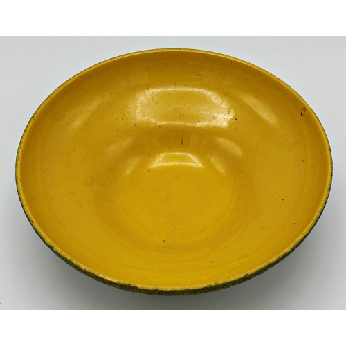 465 - West German studio pottery bowl with yellow glazed interior and green textured exterior with repeati... 