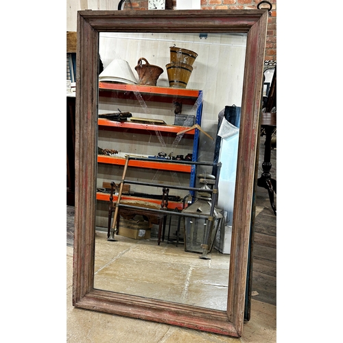 1134 - A good decorative Indian teak framed wall mirror with distressed red paint, 140 x 84cm