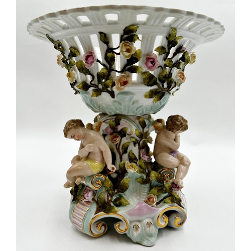 419 - German (probably Dresden) porcelain centrepiece, with pierced bowl with trailing roses over three op... 