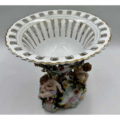 419 - German (probably Dresden) porcelain centrepiece, with pierced bowl with trailing roses over three op... 