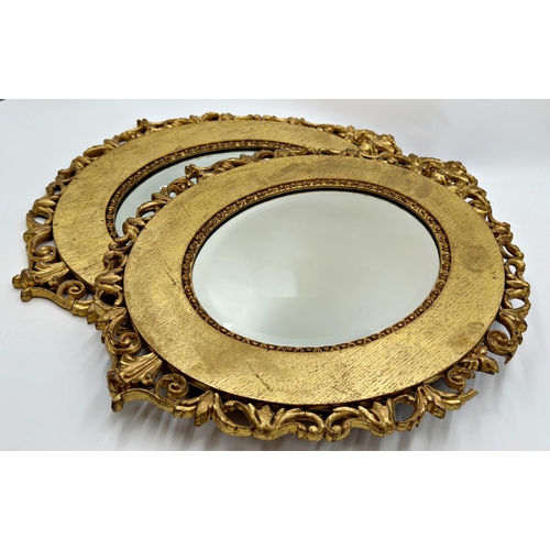 1137 - A pair of Antique Florentine style giltwood framed oval wall mirrors with bevelled glass plate, 56cm... 