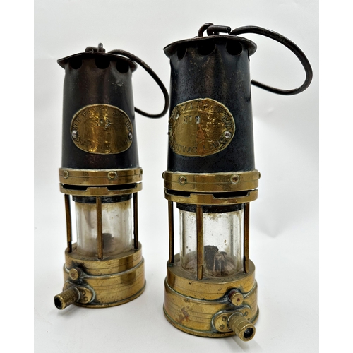 1174 - Pair of brass and steel miners lamps by W E Teale & Co Limited of Swinton, Lancs, 24cm high (2).