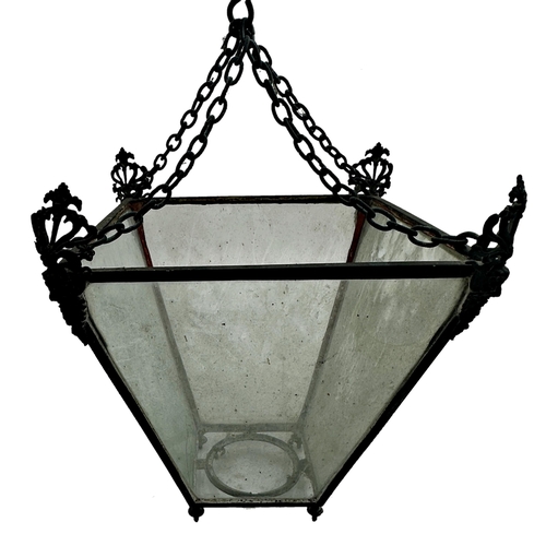 1179 - 19th century iron framed tapered hanging hall lantern fitted with four glass panels, the corners wit... 