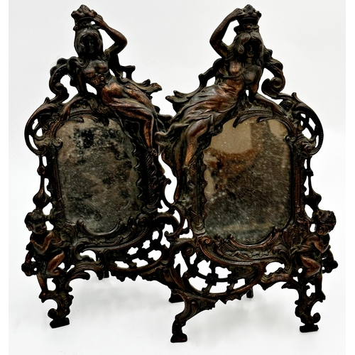 624 - Pair of bronzed cast metal easel mirrors each mounted by a reclining semi-nude maiden and cherubs wi... 