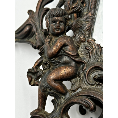 624 - Pair of bronzed cast metal easel mirrors each mounted by a reclining semi-nude maiden and cherubs wi... 