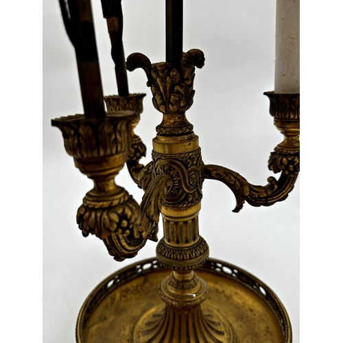 1187 - A French ormolu three branch table lamp with three rococo branches upon a decorative column and dish... 