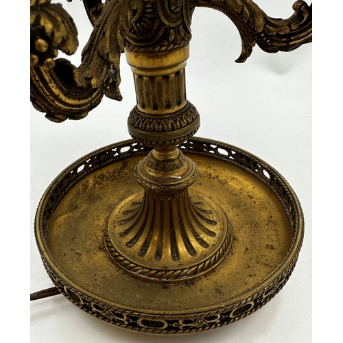 1187 - A French ormolu three branch table lamp with three rococo branches upon a decorative column and dish... 