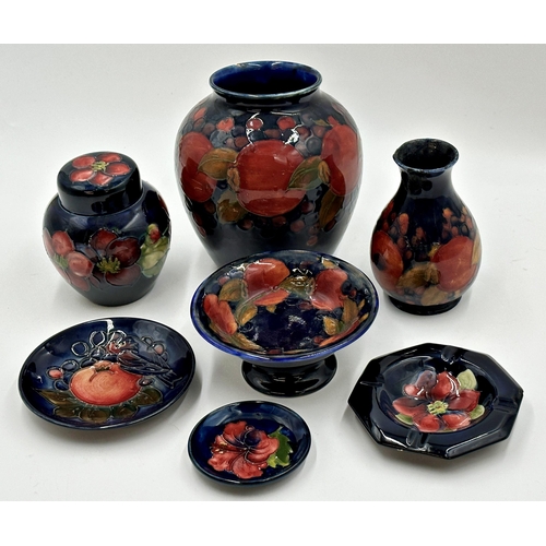 411 - Collection of Moorcroft pottery to include pomegranate vase 15cm high, further vase, lidded scent ja... 