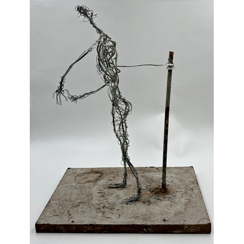 1254 - Unusual figural wirework sculpture upon a plinth base, 53cm high.