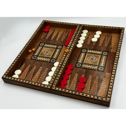 566 - Good quality late 19th century parquetry backgammon games box with counters and dice, 49cm x 49cm