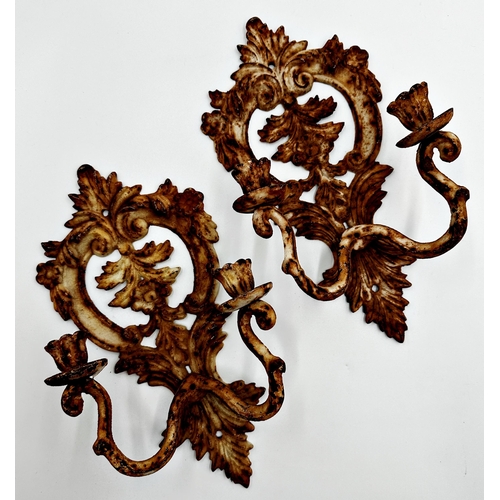 604 - A pair of cast iron twin branched wall sconces with pierced floral back plates, 34cm high (2).