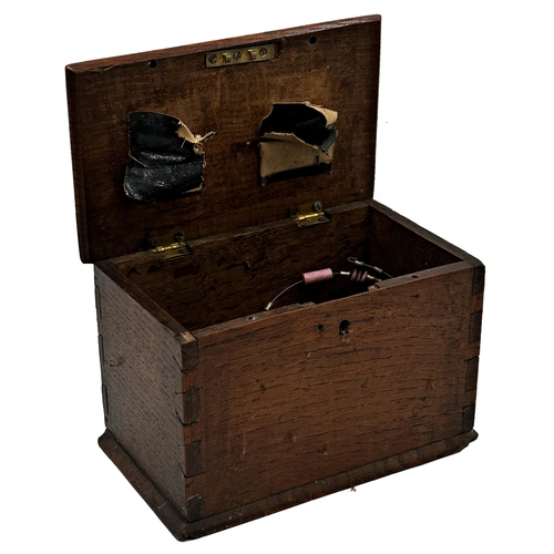 579 - 19th century primitive oak collection box the hinged lid with two holes for coins, containing large ... 