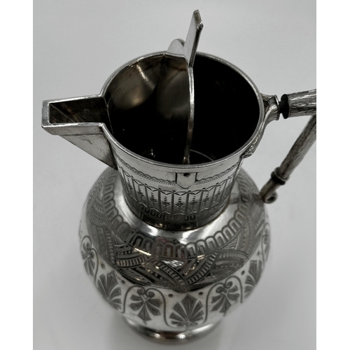 329 - In the manner of Christopher Dresser- A silver plated aesthetic period water jug engraved with Arts ... 