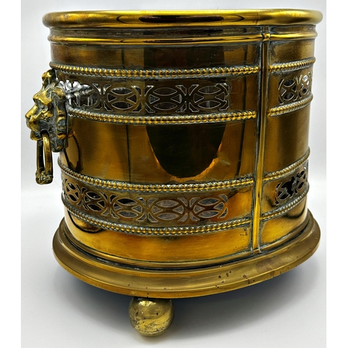 651 - Good 19th century brass oval log bin with twin cast lionhead ring handles, pierced Celtic bands and ... 