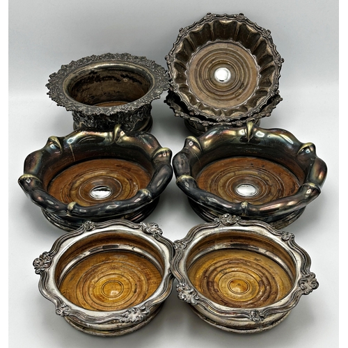 336 - Three pairs of antique silver plated wine coasters with turned wooden bases together with a further ... 