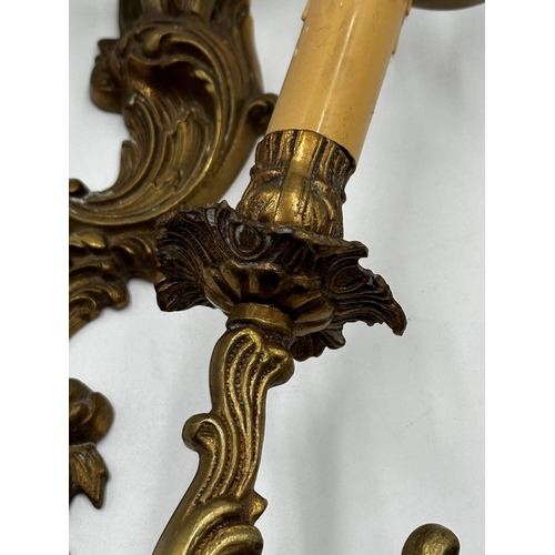 1180 - Set of four gilt metal twin branch rococo wall lights, 45cm high (4)