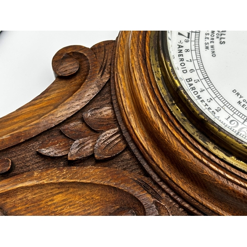 73 - Oak aneroid barometer with mercury thermometer, 91cm high