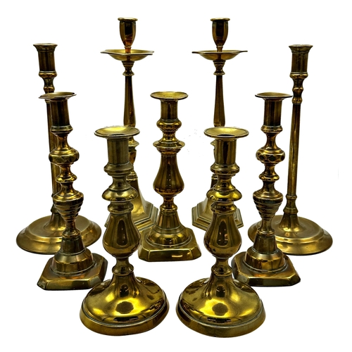 639 - Five pairs of antique brass candlesticks