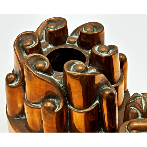 640 - Pair of antique copper jelly moulds in the manner Benham and Froud, 12cm high (2)