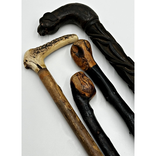 741 - Four various primitive walking sticks to include a tribal hardwood elephant stick, two cudgels and a... 