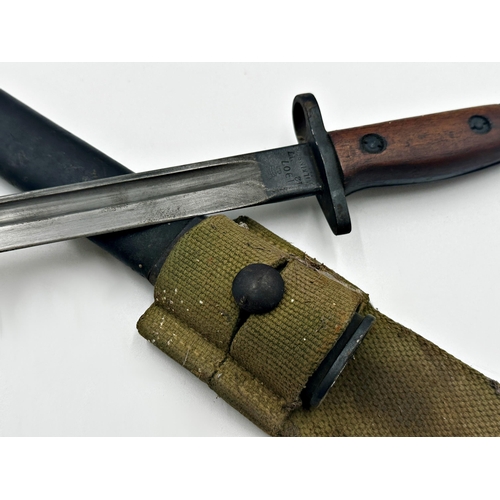 376 - A military Wilkinson bayonet with original sheath and wooden hilt, 58cm long