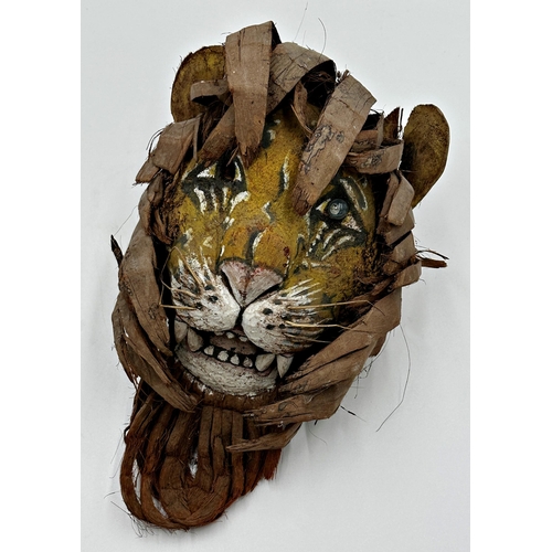 513 - Unusual wooden tribal mask of a tiger, with leaf main, 36cm high