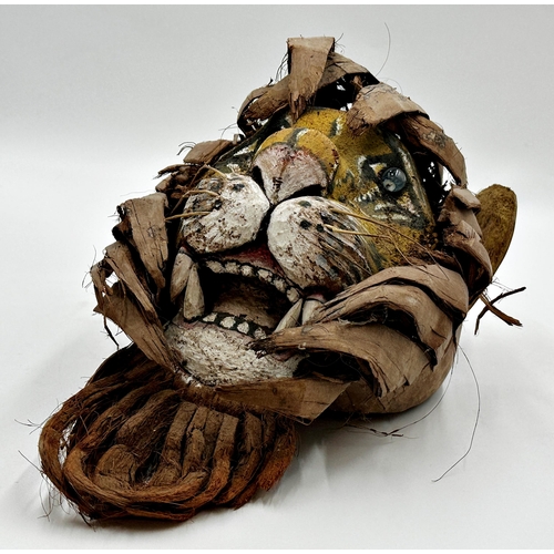 513 - Unusual wooden tribal mask of a tiger, with leaf main, 36cm high