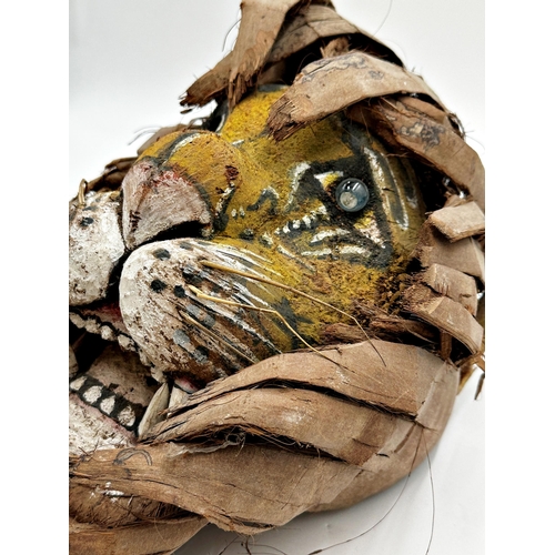 513 - Unusual wooden tribal mask of a tiger, with leaf main, 36cm high