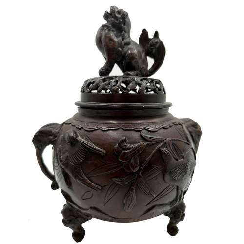 520 - Japanese bronze lidded Koro, mounted by a temple god, cast in relief with birds and twin elephant ha... 