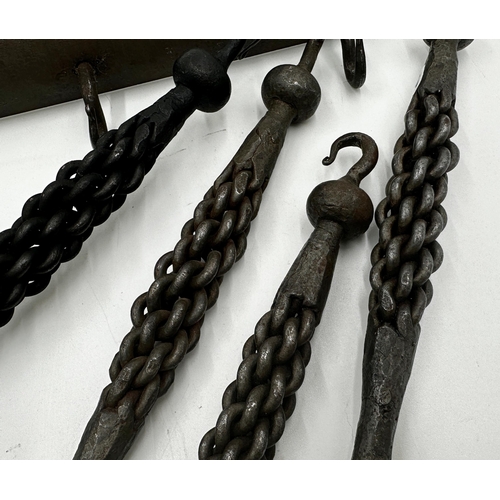 626 - Good quality iron four piece fire tool set with unusual plaited hand grips, together with an iron ha... 