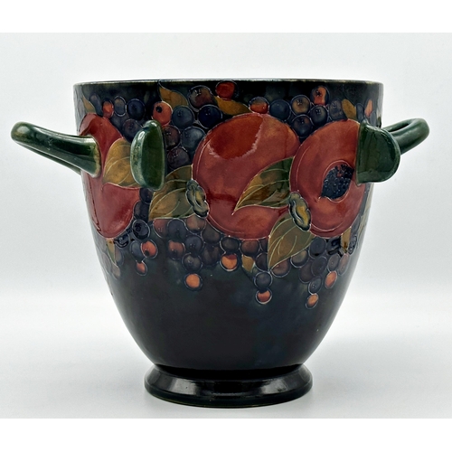 496 - Large early Moorcroft twin handled vase with four lugs in pomegranate pattern, 22cm high