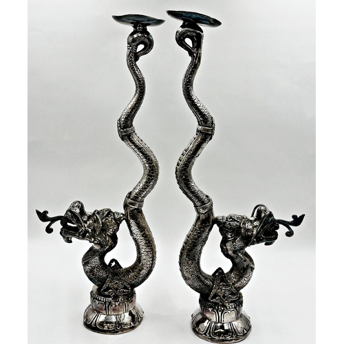 512 - A pair of far Eastern silver plated floor standing candlesticks in the form of coiled serpents, 60cm... 