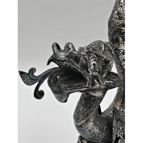 512 - A pair of far Eastern silver plated floor standing candlesticks in the form of coiled serpents, 60cm... 