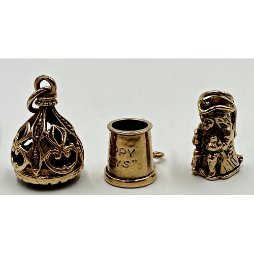 123 - Two 9ct charms - a Toby jug with hinged base and tankard, with a further gold and smoked quartz seal... 