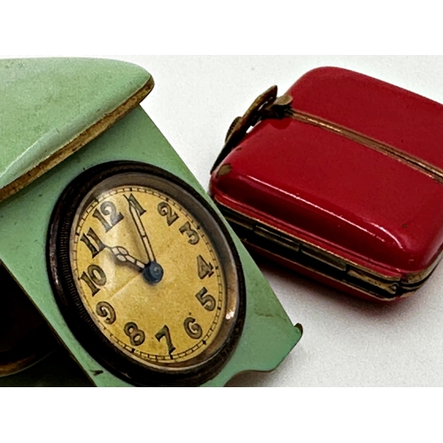 61 - Two Art Deco brass and enamel hinged purse clocks