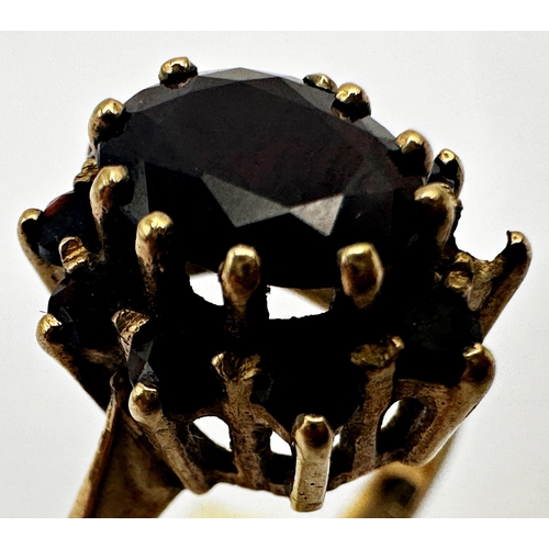 158 - 9ct garnet cluster ring, size P/Q, 4.4g (one stone vacant)