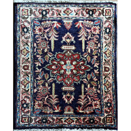 1580 - Persian rug, central red medallion and scrolled foliage on navy blue ground, L88 x W72cm