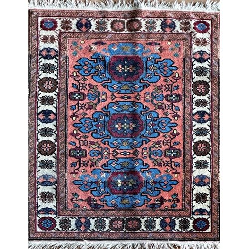 1581 - Turkish rug, three blue medallions on a washed red ground, L115 x W84cm