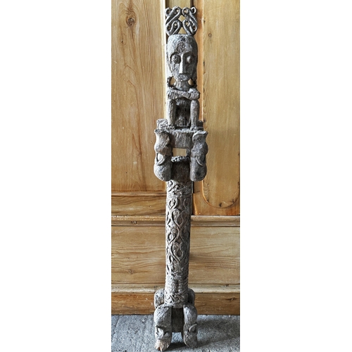 517 - Tribal interest- Carved hardwood tiki type pole mounted by a seated tribesman, 126cm high