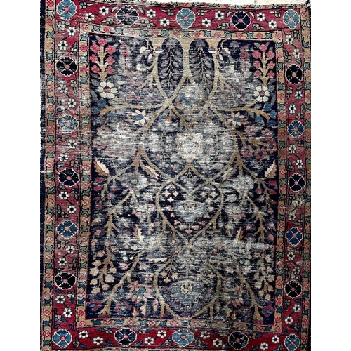 1588 - A once magnificent Persian Tree of Life rug on navy blue ground, L117 x W84cm